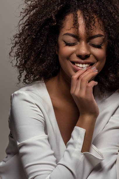 istock woman in white shirt isolated on grey background 901161464