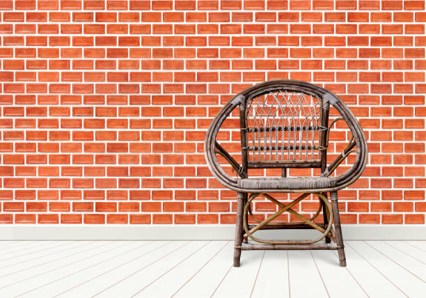 Wicker armchair / old chair on red brick wall background. decoration room interior