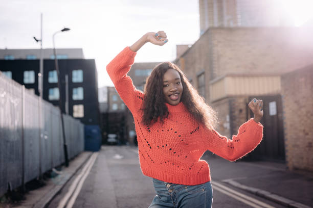 istock Ecstatic Cameroon woman smiling and raising her arms 901163574