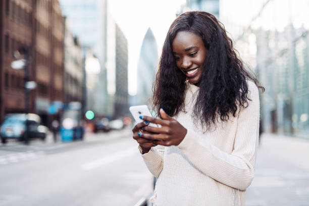 istock Ecstatic Kenyan woman using mobile app in England 901168484