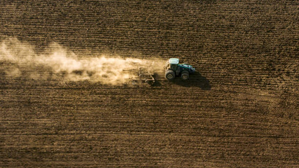 istock AERIAL Tractor ploughing vast field in sunshine 901169610