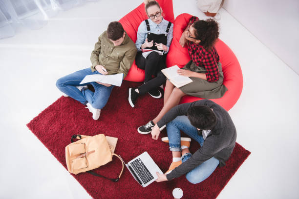 istock multicultural teenagers studying with laptop and exercise books 901172600