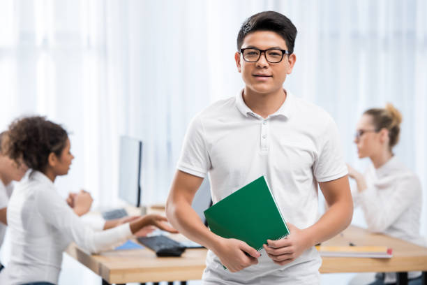 istock young asian student boy in classroom with friends 901174220