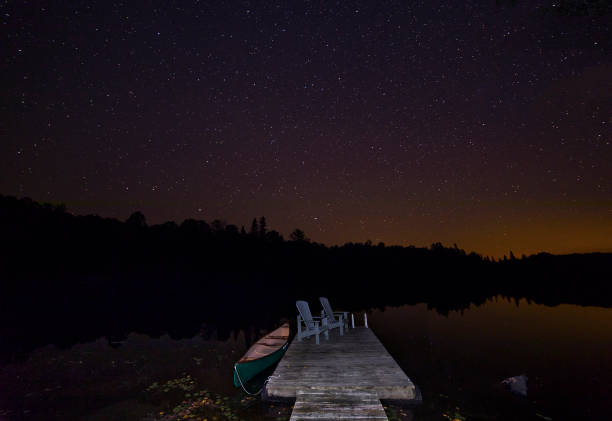 istock Canoe and dock under a September night sky 901176818