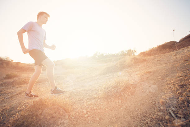 Running Young Man. Male Runner Sprinting During Outdoors Training for Marathon Run. Fit Young Sport Fitness model Outdoor. Concept for Exercising, Fitness and Healthy Lifestyle