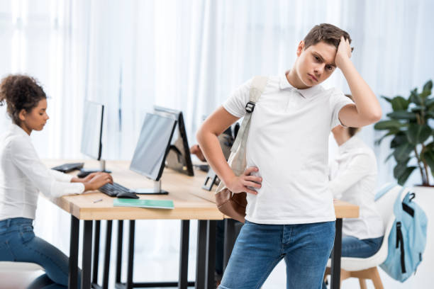 istock young pensive caucasian student boy in classroom with friends 901179468