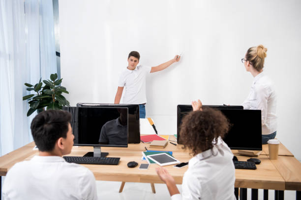 istock young teenager pointing on white board in classroom with students 901183072