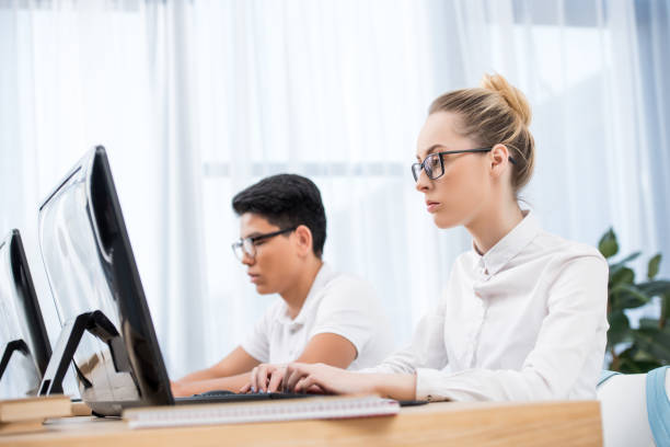 istock young teenager students studying on computers 901185490