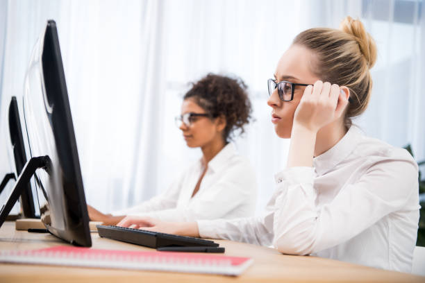 istock young tired teenager girls studying on computers 901186078