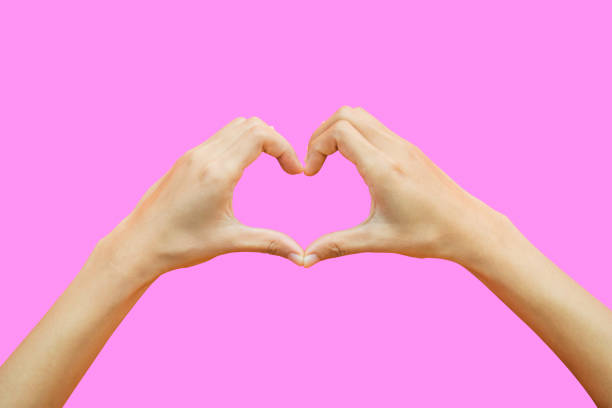 istock Female hands shaping a heart symbol isolated on pink background include clipping path 901190096