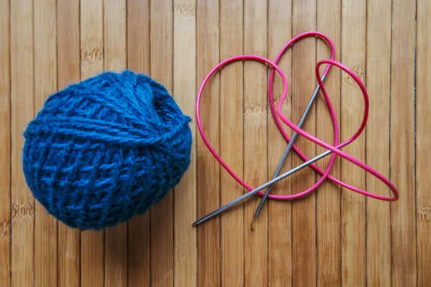 Knitting wool and knitting needles as a concept of handwork and hobbies. Threads in a tangle.