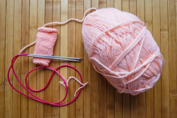 Knitting wool and knitting needles as a concept of handwork and hobbies. Threads in a tangle.