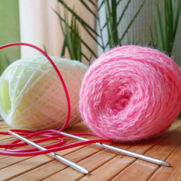 Knitting wool and a woolen ball - as a concept of hobbies and handmade creativity.