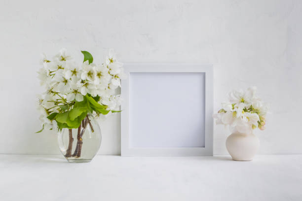 istock Mockup with a white frame and white flowers 901194690