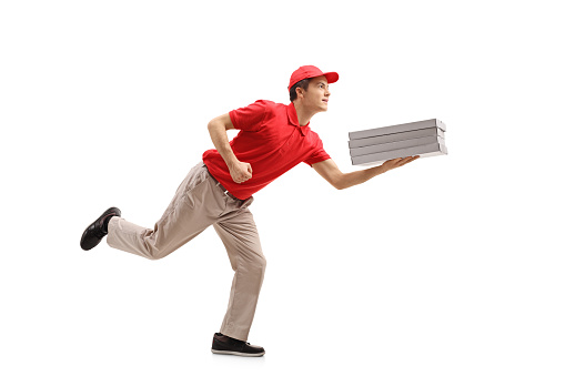 Full length profile shot of a teenage pizza delivery boy running isolated on white background