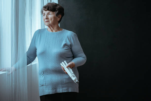 istock Woman with folded white cane 901199120