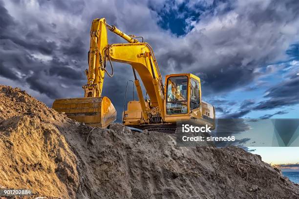 A Stopping Yellow Excavator Stock Photo - Download Image Now - Backhoe, Earthwork, Mining - Natural Resources