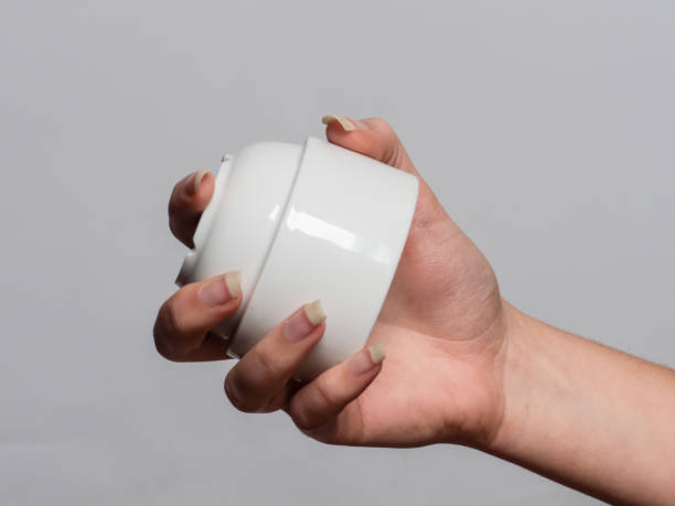 istock Soft female hand holding various objects with gel fingernails 901203006