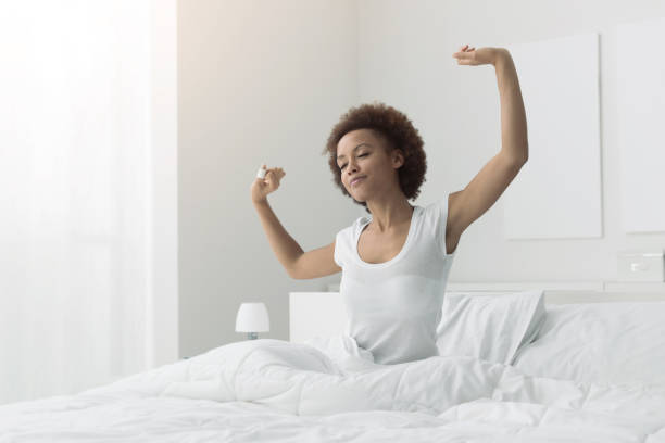istock Woman waking up and stretching 901203300