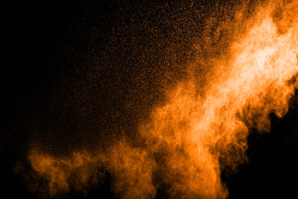 istock abstract orange powder explosion on black background. abstract orange dust splattered on  black background. Freeze motion of orange powder splash. 901205800