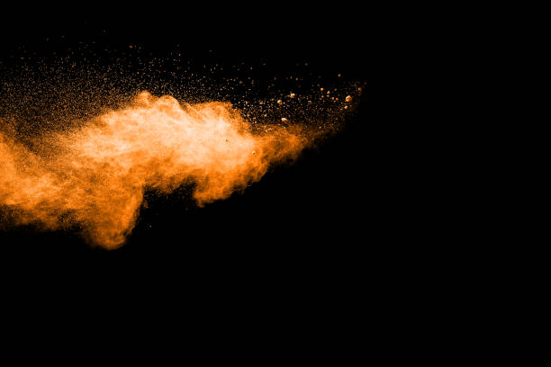 istock abstract orange powder explosion on black background. abstract orange dust splattered on  black background. Freeze motion of orange powder splash. 901205802