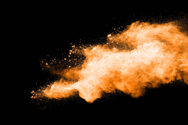 istock abstract orange powder explosion on black background. abstract orange dust splattered on  black background. Freeze motion of orange powder splash. 901205884