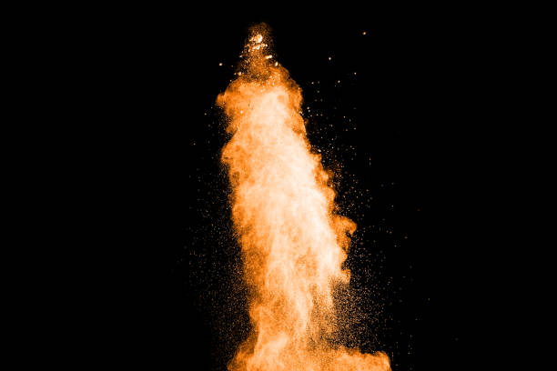 istock abstract orange powder explosion on black background. abstract orange dust splattered on  black background. Freeze motion of orange powder splash. 901205886