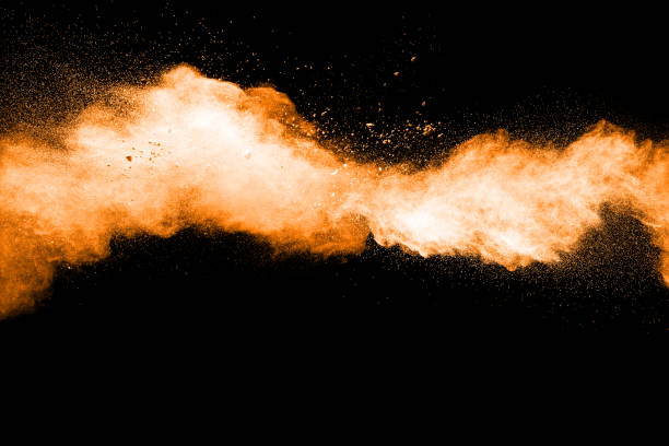 istock abstract orange powder explosion on black background. abstract orange dust splattered on  black background. Freeze motion of orange powder splash. 901205920
