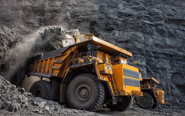 loading of coal in a quarry dumper front loader loading of coal in a quarry dumper front loader coal mine photos stock pictures, royalty-free photos & images