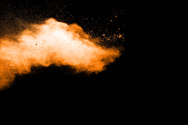 istock abstract orange powder explosion on black background. abstract orange dust splattered on  black background. Freeze motion of orange powder splash. 901205958
