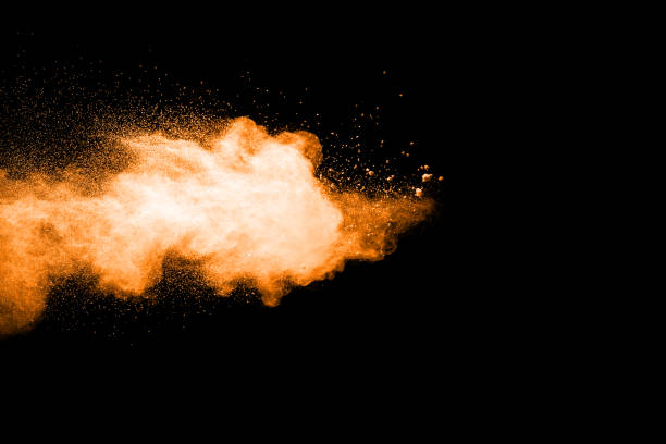 istock abstract orange powder explosion on black background. abstract orange dust splattered on  black background. Freeze motion of orange powder splash. 901206002