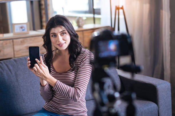 istock Nice young woman showing her smartphone 901206374