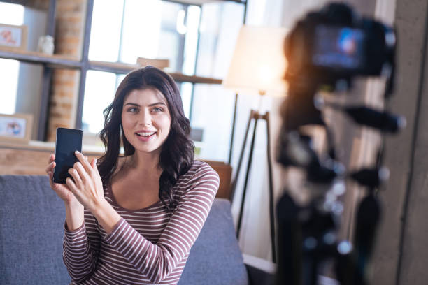 istock Joyful attractive woman pointing at her smartphone 901206462