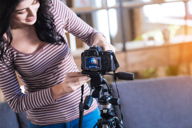 istock Delighted nice woman putting camera on a tripod 901207662