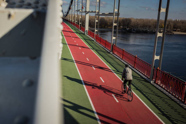 istock high angle view of man riding bicycle on pedestrian bridge over river 901207718