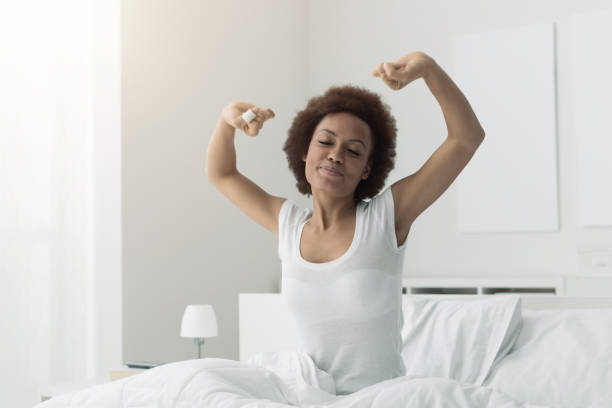istock Woman waking up and stretching 901207892
