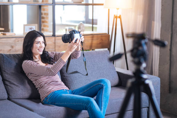 istock Cheerful happy woman sitting on the sofa 901207918