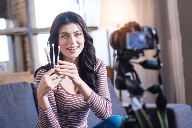 istock Happy delighted woman holing makeup brushes 901208254