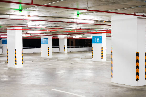 istock Interior car park zone with white line for car and green sensor wireless control on ceiling for status 