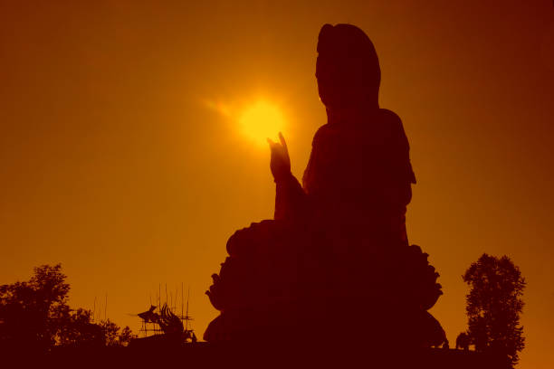 istock Black silhouette buddha with a sunset background.religious 901208750