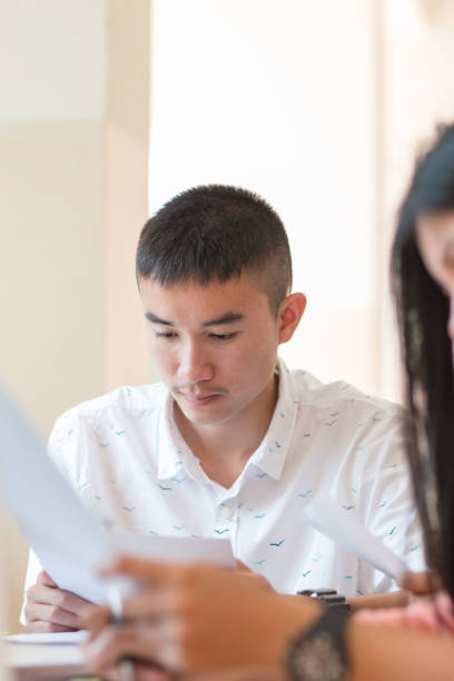istock Students Asian man or Startup business working groups with documents paper for report in classroom. Asian High school students learning and meeting for projected in seeminar. Education concept 901209218