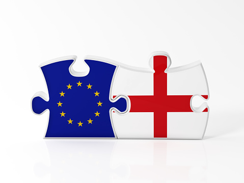 Jigsaw puzzle pieces textured with European Union and English flags on white. Horizontal composition with copy space. Clipping path is included.