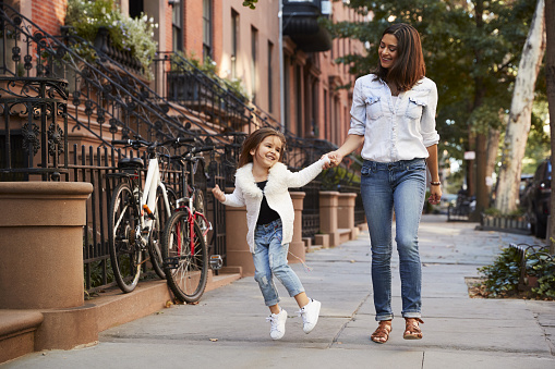 Mother and daughter walking down the street