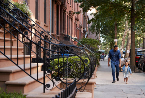 istock Father and daughter taking a walk down the street 901212248