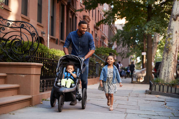 istock Father and two daughters taking a walk down the street 901212452