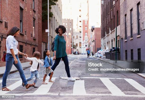 Two Mother Friends With Two Daughters Crossing The Road Stock Photo - Download Image Now