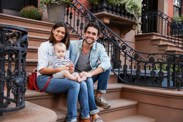 istock Young family with kids sitting on front stoops 901212754