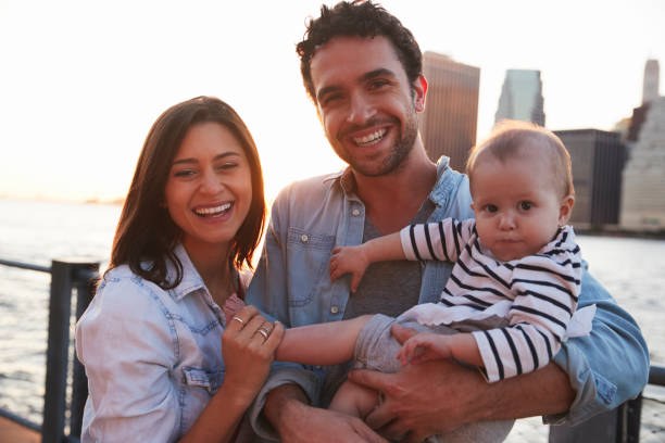 istock Young family with daughter standing on quayside, close up 901214966