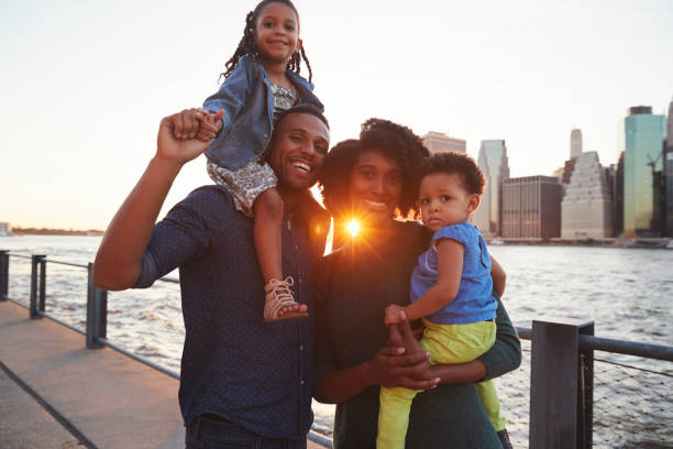 istock Young family with daughters standing on quayside 901214986