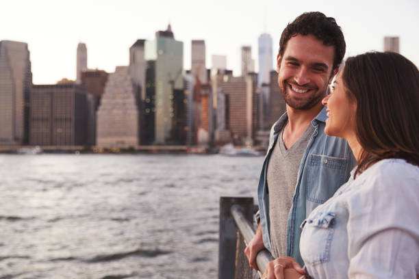 istock Young couple standing on quayside, side view 901215062